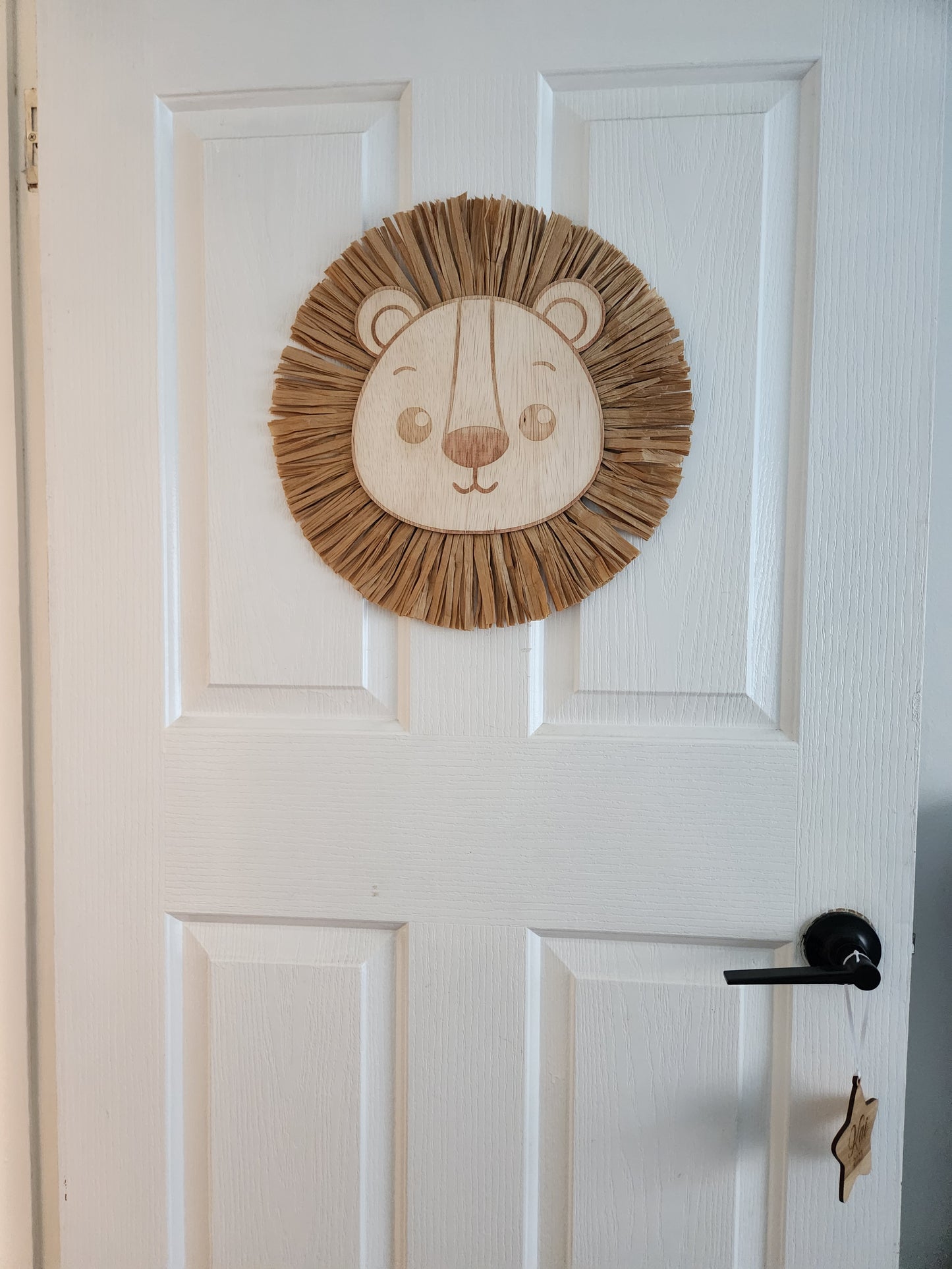 Raffia lion head sculpture by Kai & I Design featuring detailed woven raffia mane and facial features.