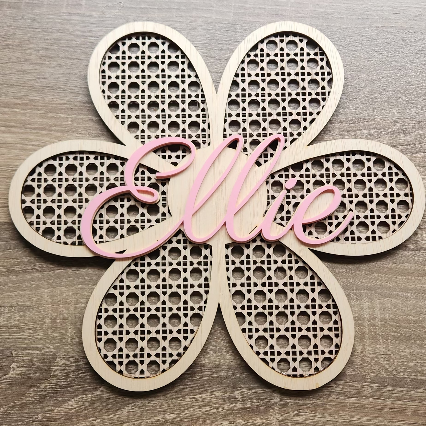 Custom Boho Daisy name sign decoration by Kai & I Design, featuring wooden daisies and colorful lettering for kids' room decor.